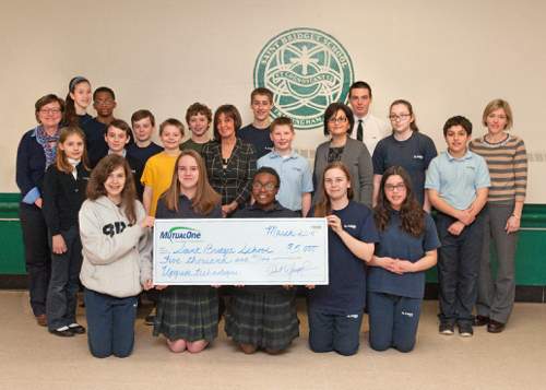 Students and faculty at St Bridget School in Framingham celebrate the MutualOne Charitable Foundation’s recent $5,000 award to upgrade technology.