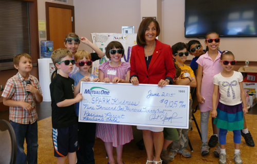 Rachel Stewart (center), administrative director, MutualOne Charitable Foundation, celebrating the Foundation’s grant to SPARK Kindness along with children from the program.