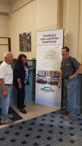 Construction worker showing Bank employees the Natick office renovation floor plan