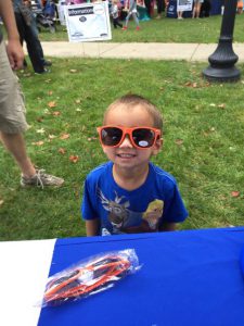 Little boy wearing MutualOne Bank sunglasses at Natick Days