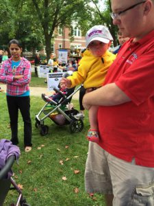 Baby wearing "Natick" hat at Natick Days