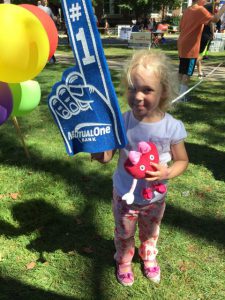 Little Girl holding foam finger at Natick Days