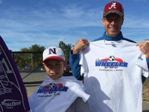 Attendees at 20th George Wheeler Cup hold up event t-shirts