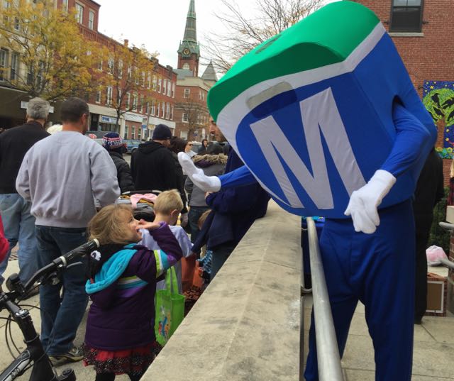 Mo giving high fives to children in the Natick Halloween Parade