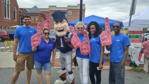 MutualOne Bank employees wearing foam fingers with Pat the New England Patriots' mascot at Natick Days