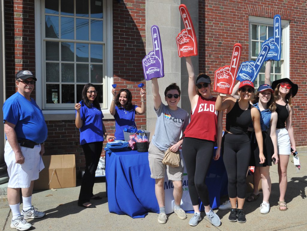 Group of Boston Marathon attendees holding foam fingers with MutualOne employees