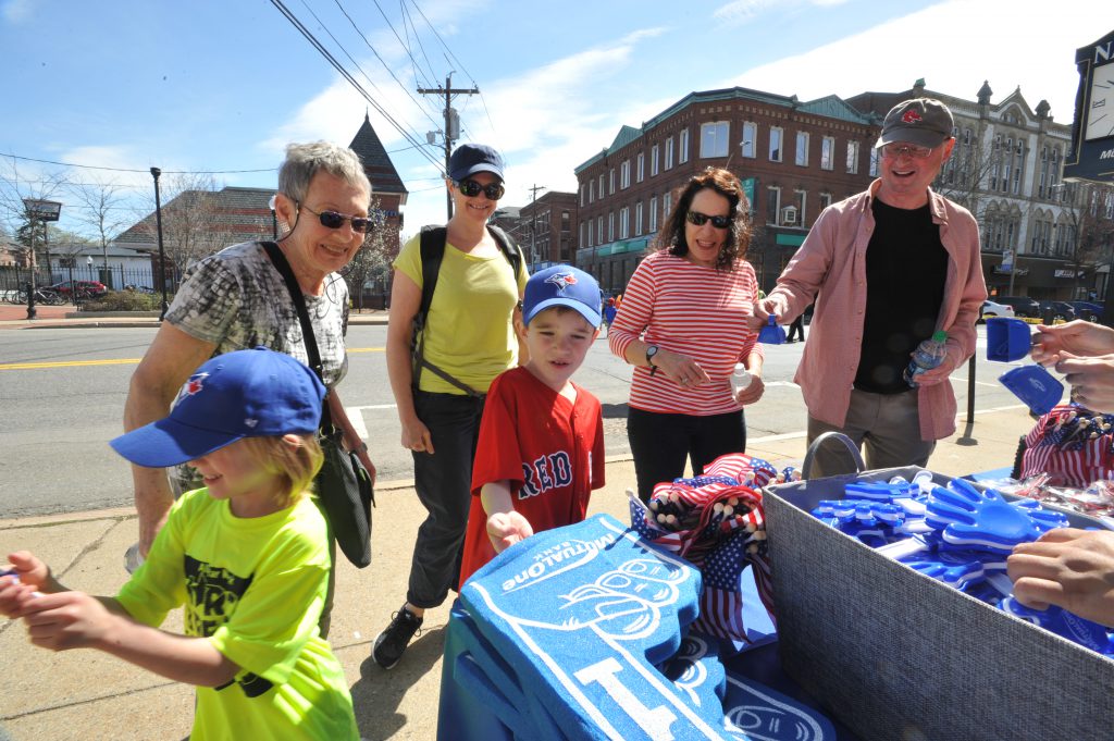 Family looking over the giveaways at MutualOne Bank table