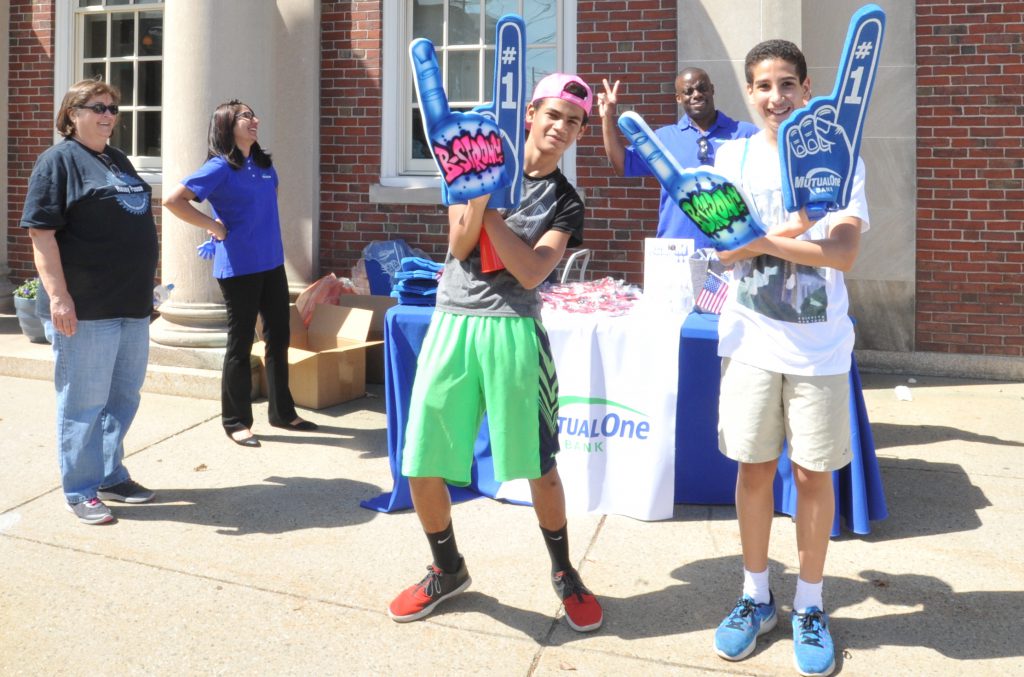 Two men holding B-strong foam fingers and MutualOne Bank foam fingers