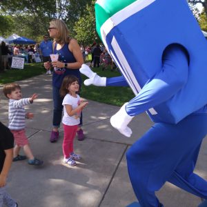 Natick Days Mo giving high five to two children