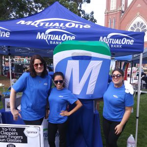 Natick Days Mo with three people at MutualOne tent