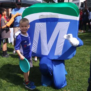 Natick Days Mo pointing with boy with frisbee