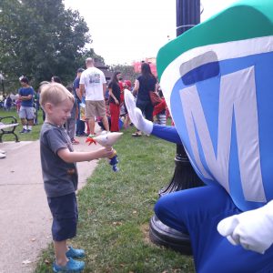 Natick Days Mo giving a high five to little boy