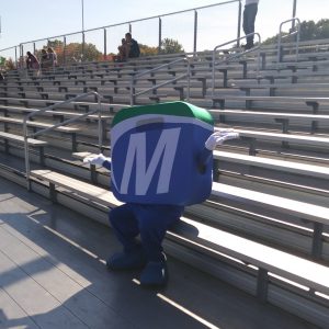 Mo sitting on bleachers