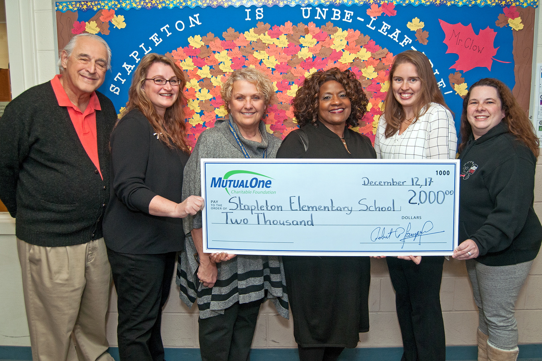 Celebrating MutualOne Charitable Foundation’s recent $2,000 grant to the Stapleton Elementary School’s STEAM night are (l-r) Volunteers Allan Rosenberg and Michelle Rosenberg; Allison Benabdallah, Stapleton assistant principal; Jean Hoskins, MutualOne Bank’s Concord Street, Framingham office manager; Heather Allen, Grade 3 teacher and STEAMathon co-chair; and volunteer Meredith Wolff.