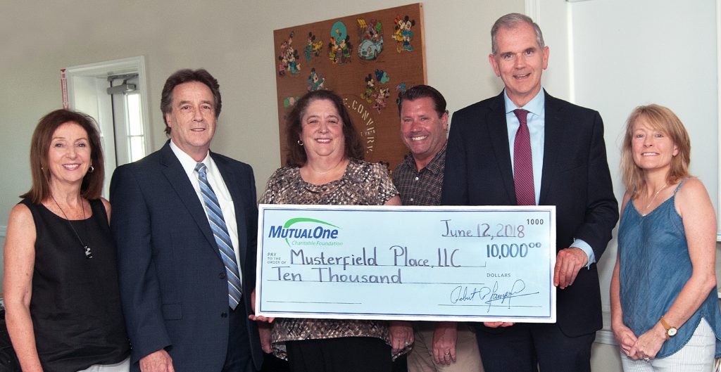 MutualOne Charitable Foundation’s $10,000 grant to Musterfield Place is celebrated by (l-r) Janice Rogers, commissioner of the Framingham Housing Authority; Mark Haranas, president and CEO of MutualOne Bank; Darlene Herweck, property manager at Musterfield Place; Ryan Carey, activity coordinator at Musterfield Place; Paul Landers, executive director and Janet Leombruno, commissioner of the Framingham Housing Authority.