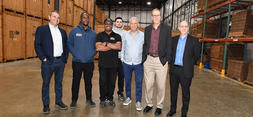Group of people in a warehouse.