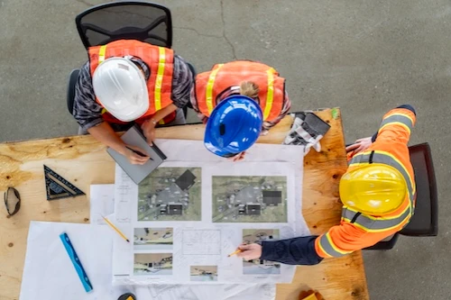 Overhead of contractors around a blueprint