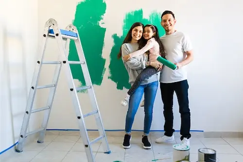 Young family painting a wall