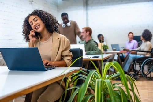 Woman in an office speaking on a phone