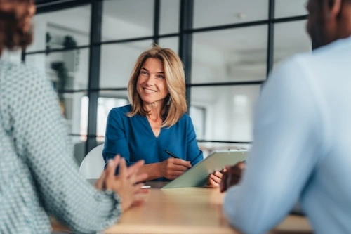 Woman speaking with two people