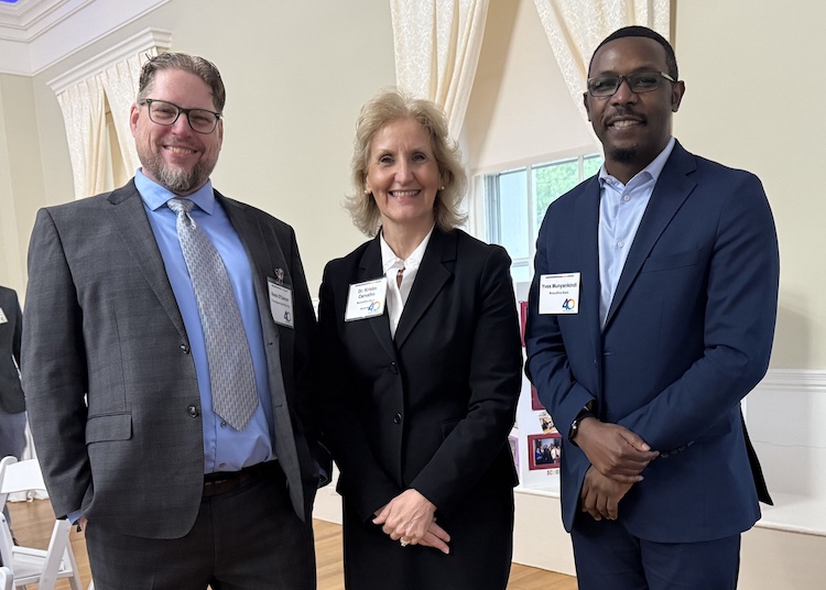 Three people posing for a picture.