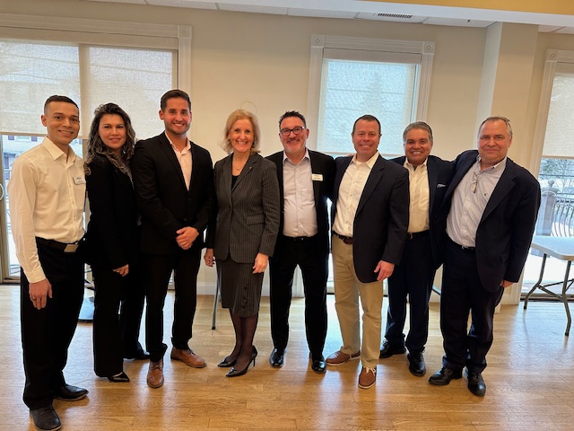 Group photo with 8 people in a row.