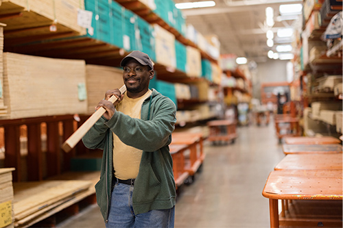 Tradesman buying lumber from hardware store